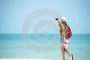 Happy traveler and tourism women travel summer on the beach.Â 